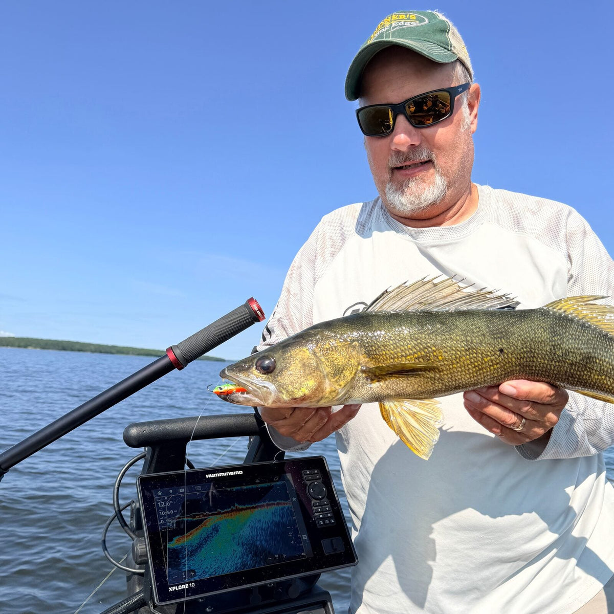 Walleye held beside the Pro Pole and a Fish Armor shuttle