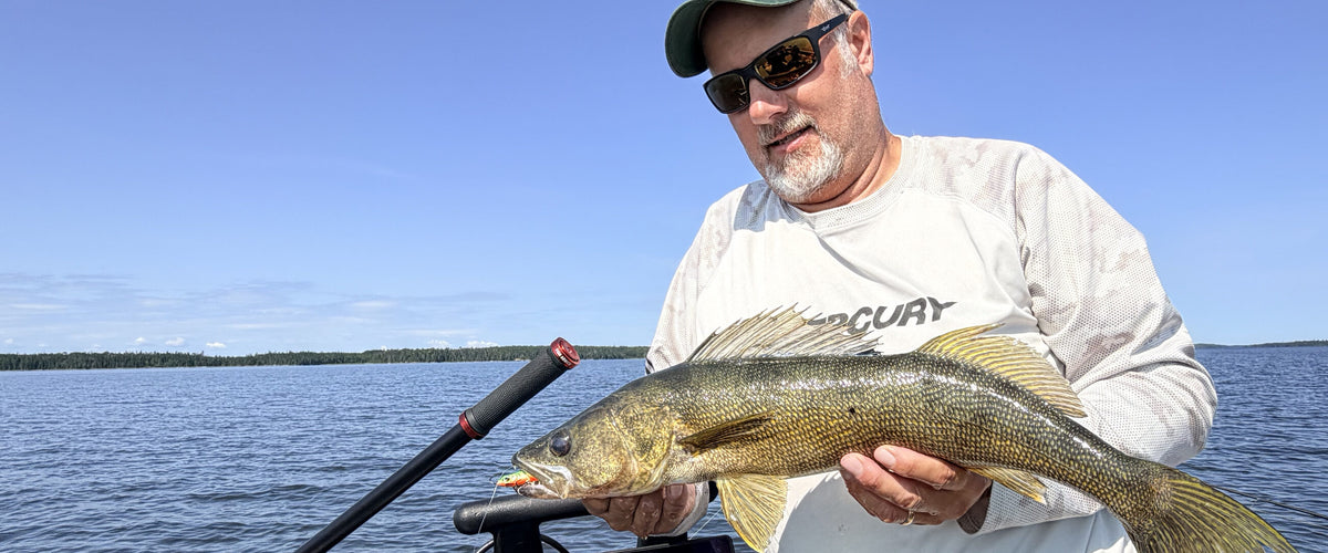 Angler with a walleye beside the Fish Armor Pro Pole handle