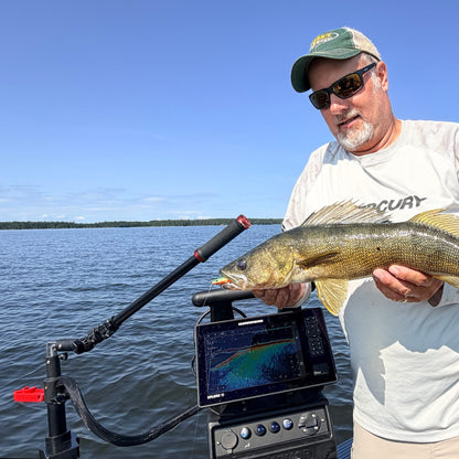 Angler with a walleye next to the Pro Pole and Twist Handle